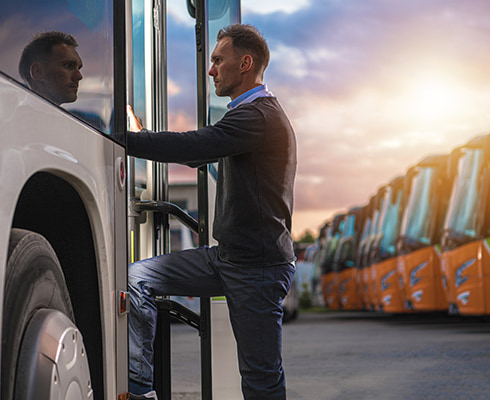 A coach bus driver behind the wheel