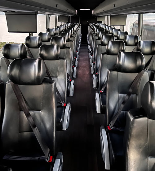 Interior of a bus rental with black leather seating